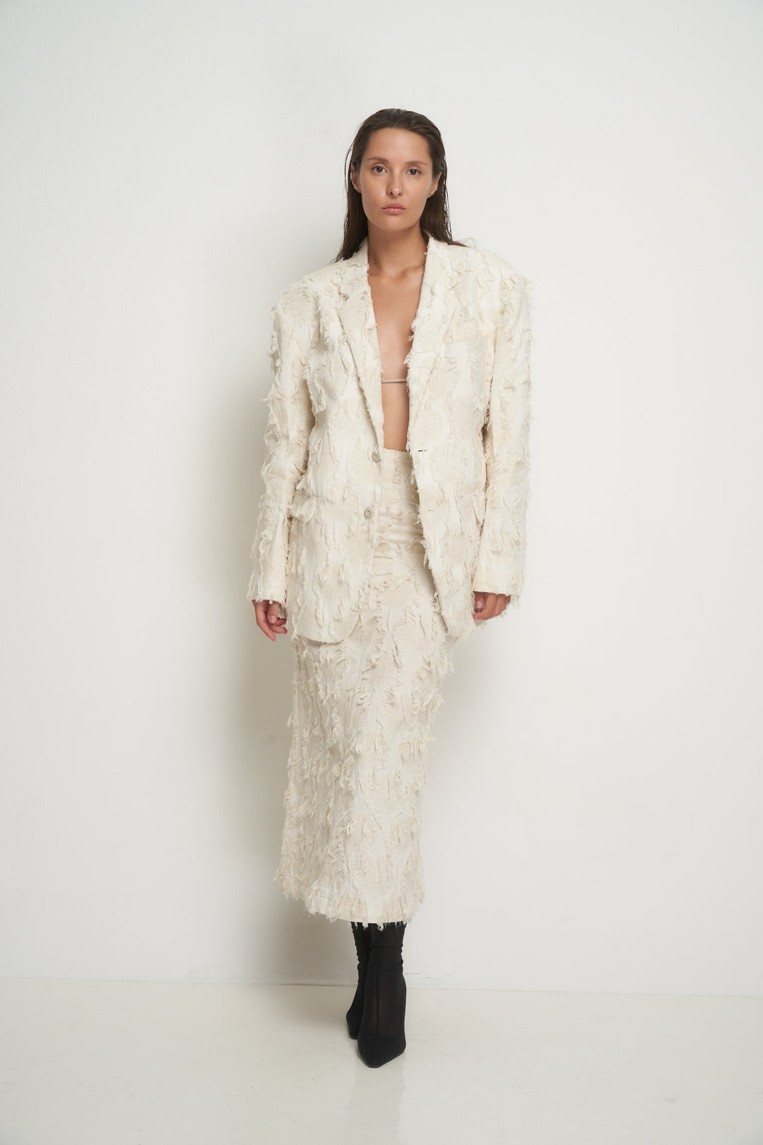 Beige jacket with torn fabric