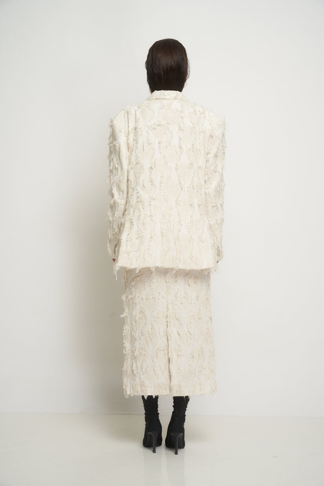 Beige jacket with torn fabric