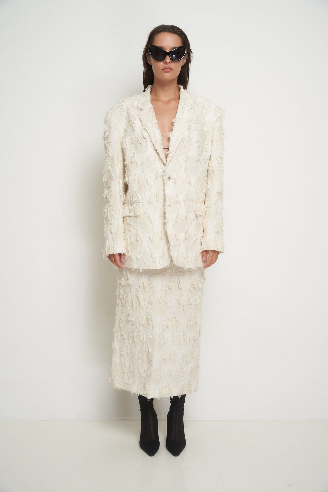 Beige jacket with torn fabric