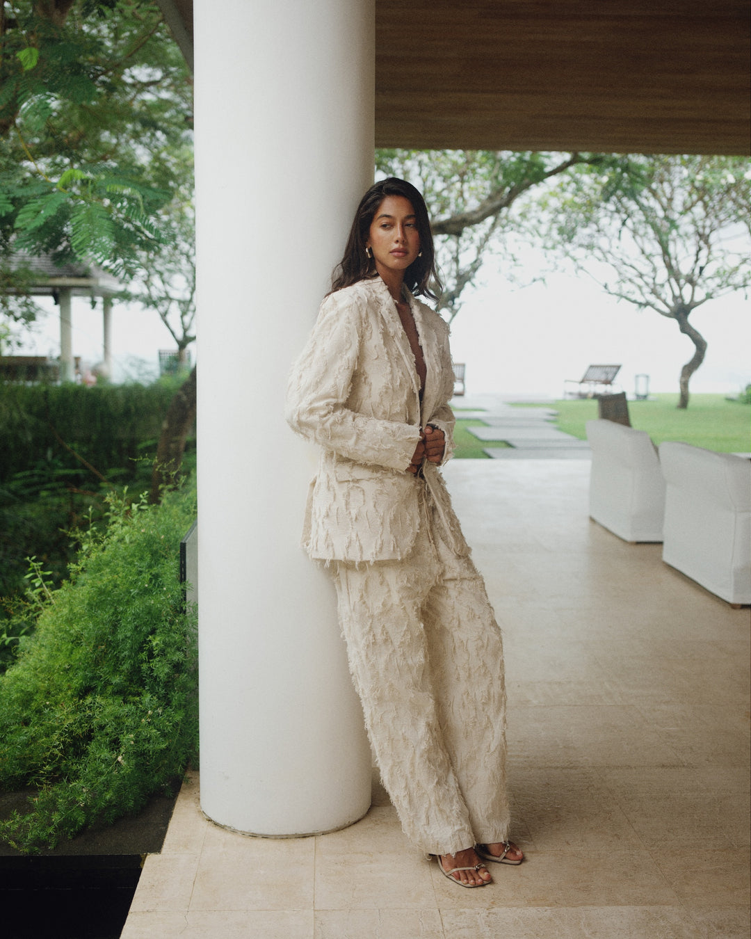 Beige jacket with torn fabric