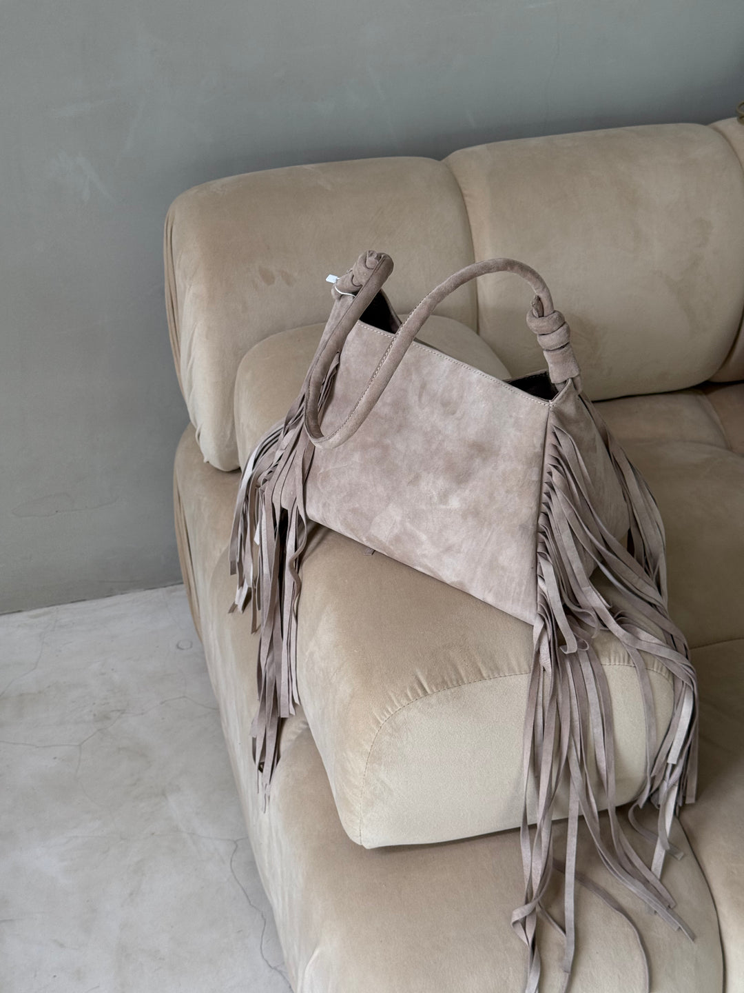 Beige suede bag with fringe