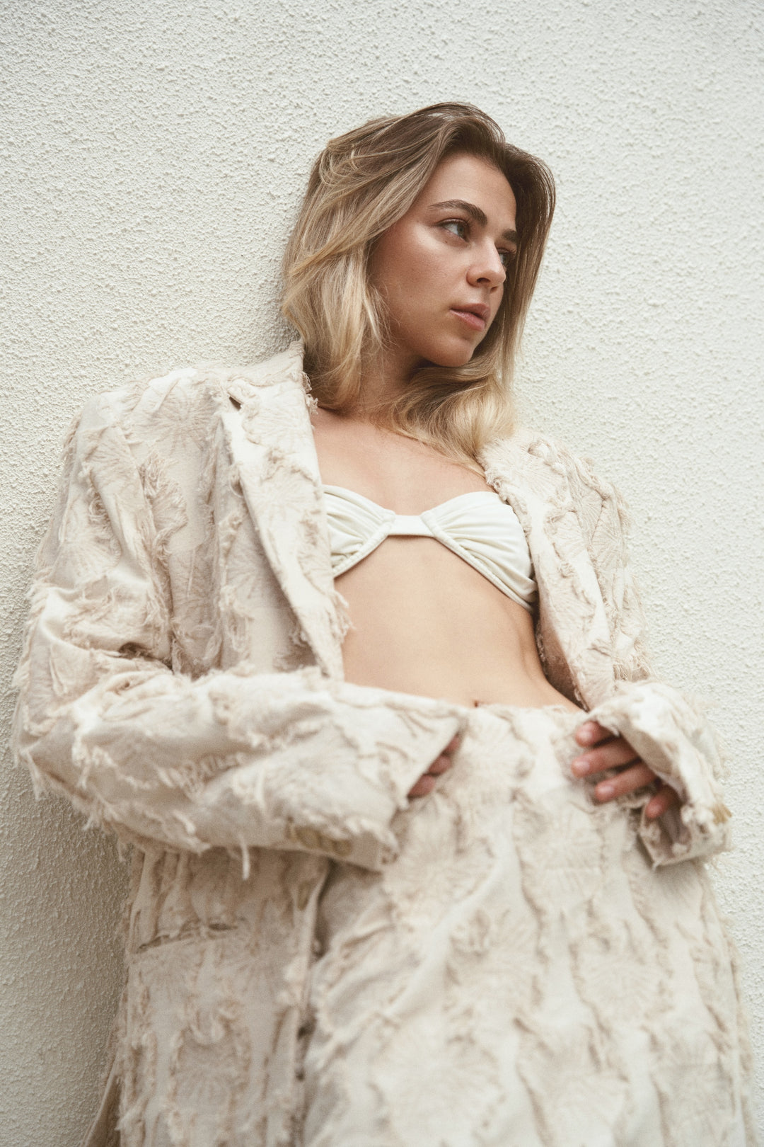 Beige jacket with torn fabric